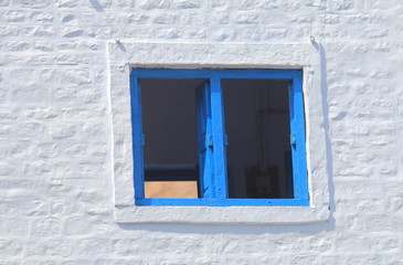 Blue window frame with white wall Jodhpur India