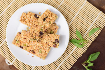Snack bar or energy bar on white dish, top view