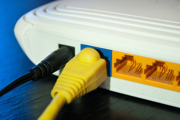 Internet cable plugs are connected to Internet Router. Close up. Selective focus.
