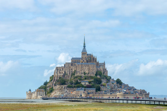 Panoramic view of famous Le Mont Saint-Michel tidal island in beautiful twilight during grey blue hour at dusk, Normandy, northern France