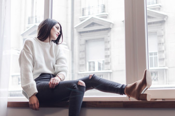 Beautiful lady sitting by the window