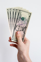 5 US dollars held in right hand.