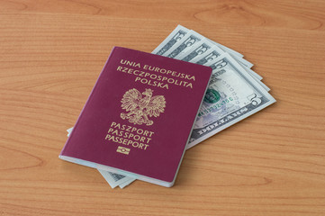 Polish biometric passport with five dollars banknotes.