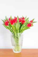 Vase with beautiful red tulip flowers bouquet.