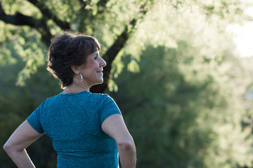 Fototapeta premium Active Woman Backlit by Sun on Hiking Trail