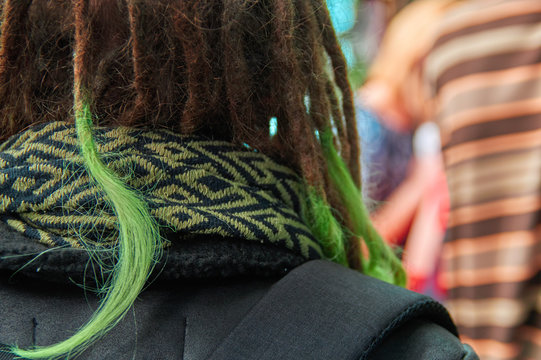 Dreadlocks with green tips of plaits closeup. Back view.
