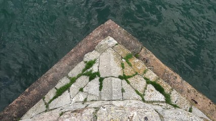 Waves crashing against jetty in harbour