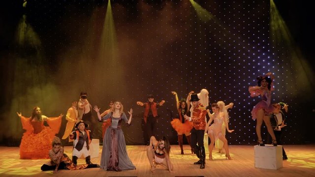 Young couple sing love song on the stage in theatre