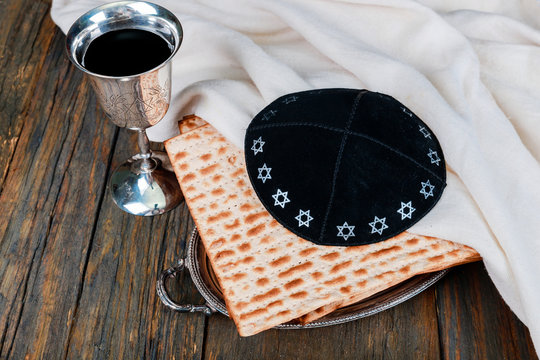 Silver wine cup with matzah, Jewish symbols for the Passover Pesach holiday. Passover concept.