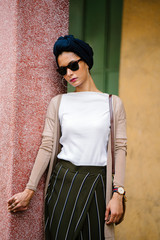 Fashion portrait of a young, slim and attractive Muslim Malay woman in a turban head scarf. She is...