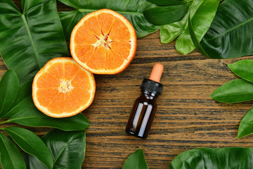 Cosmetics skincare with vitamin-c extract, Cosmetic dropper bottle containers with fresh orange slices, Blank label for branding mock-up, Natural Vitamin C beauty product concept.