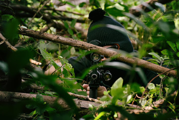 Soldiers aiming target and holding his rifles hidden ambushed, Army sniper camouflage in forest, Battle in the woods.
