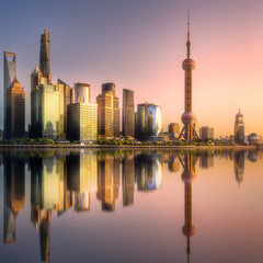 Shanghai skyline with reflection of sun on water