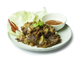 Fried sour pork, fermented pork with sauce, vegetable and chili on dish isolated on white background. sour pork is faverite presevation food in thailand. clipping path included.