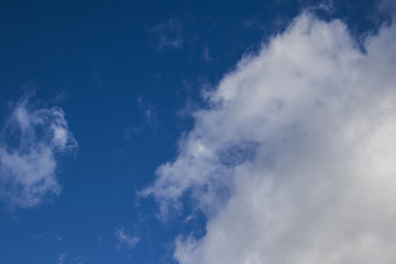 White springtime cloudscape on a solid blue sky