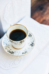 white coffee Cup and books with white covers, the concept of love of reading on table