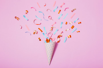birthday hat with confetti on paper background