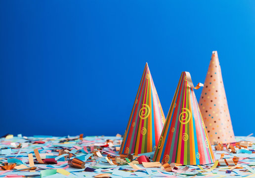 birthday hat and confetti  on blue background