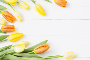yellow tulips on wooden background