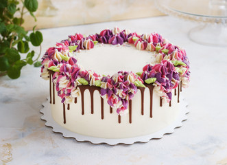 Festive cake with cream flowers hydrangea on a light background