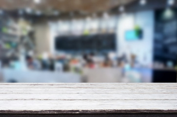 Selected focus empty brown wooden table and Coffee shop or restaurant blur background with bokeh image. for your photomontage or product display.