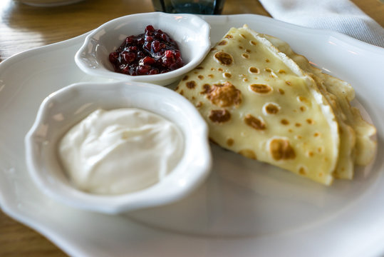 Pancakes with sour cream and jam. traditional Russian dish. Food photo. Restaurant serving. 