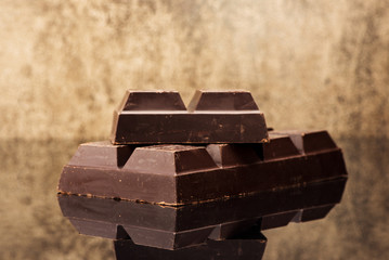 Blocks chocolate on a stone background