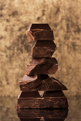 Stack chocolate on a gold stone background