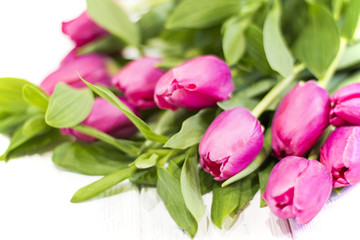 Bright pink tulips on a wooden background. Background for postcard or wallpaper