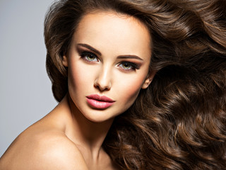 Face of a beautiful  woman with long brown  hair