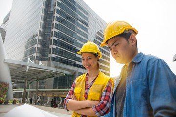 Team of architectures standing at construction site looking at progress.
