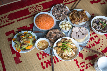 A traditional Vietnamese meal for lunar new year Tet holiday in spring, placed on new flowered sedge mat, on the last day of the last year