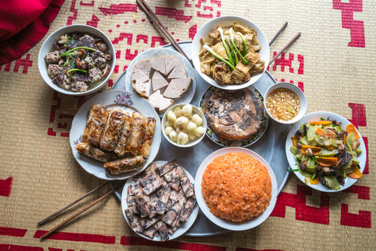 A traditional Vietnamese meal for lunar new year Tet holiday in spring, placed on new flowered sedge mat, on the last day of the last year