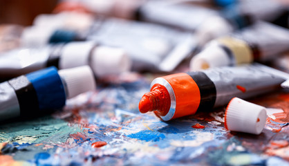 From tube on palette comes paint. Picturesque composition for still life. Dry paint. Discounts on goods for artists.