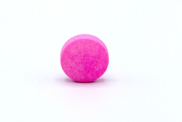 pink pill on white background .