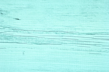 Old cracked wooden surface painted in turquoise color