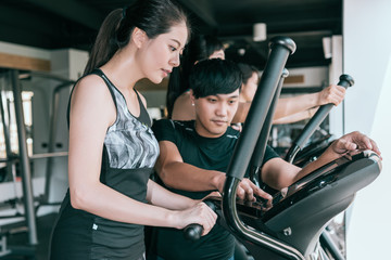Woman working out on elliptical machine.