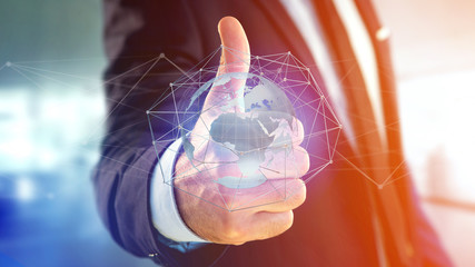 Businessman holding a Connected network over a earth globe concept on a futuristic interface - 3d rendering