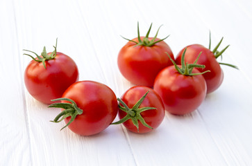 Tomatoes on a wooden white background. proper nutrition