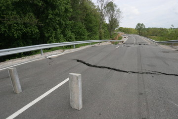 Road collapses with huge cracks. International road collapsed down after bad construction. Damaged...