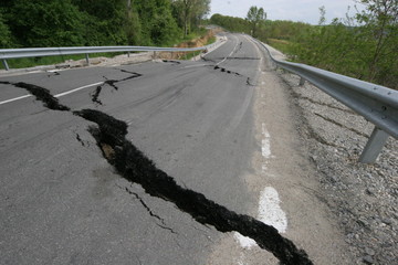 Road collapses with huge cracks. International road collapsed down after bad construction. Damaged...