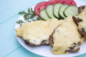 steak with vegetables on a turquoise wooden background