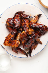 Chicken wings with two sauces on white background. Summer barbeque concept.