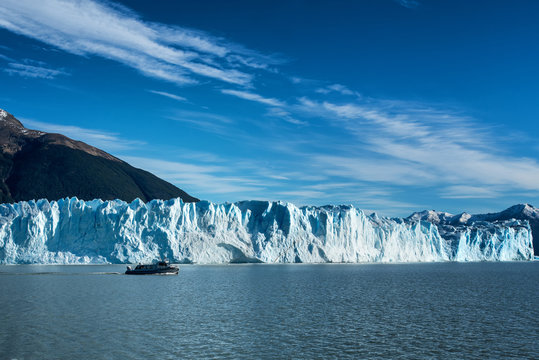 Tourist boat viewing Perito Moreno glacier outside El Calafate, Argentina in Patagonia, part of the third largest ice field in the world