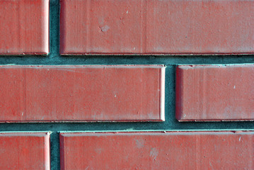 Wall with shabby plaster of soft pastel  color on red brick wall, grunge texture background