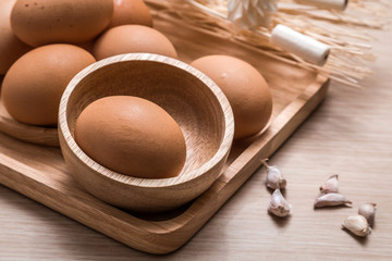 Close-up view of chicken eggs on wooden table background