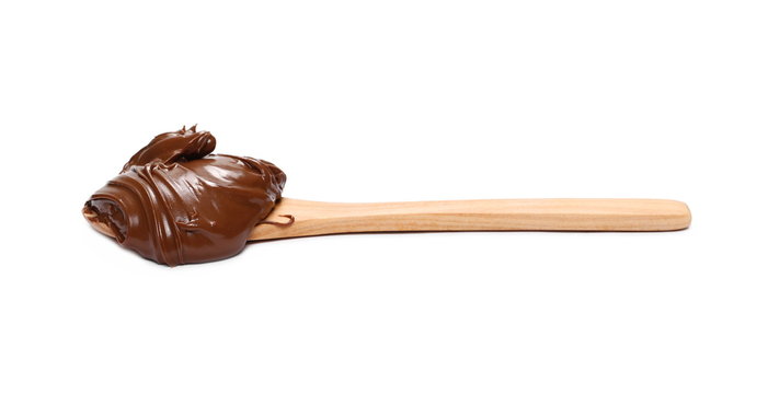Cream chocolate spreading and wooden spoon isolated on white background