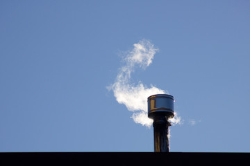 white smoke coming  out of a chimney, blue sky background