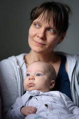 Mom and baby in peace looking out from the window