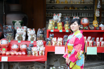 Japanese woman in Kimono is walking through Japanese souvenir shop in Kyoto, Japan.